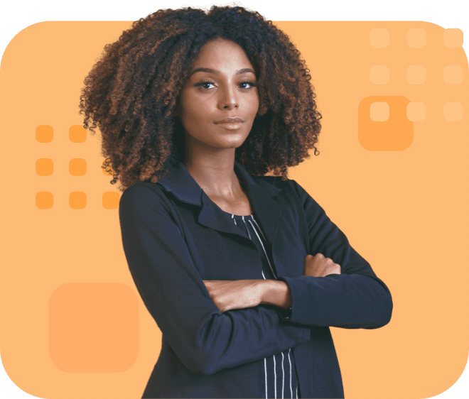 Confident individual with voluminous curly hair, wearing a dark blazer, and arms crossed.