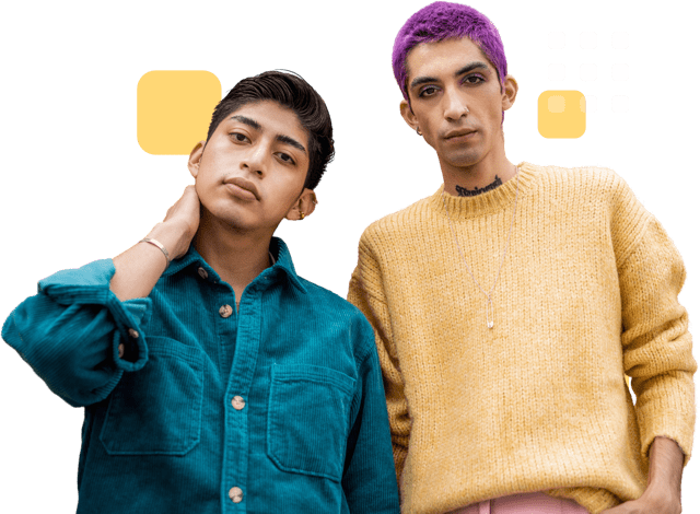Two people standing confidently; one wearing a teal button-up shirt with hand on neck, the other with short purple hair, visible tattoos, and a yellow sweater.