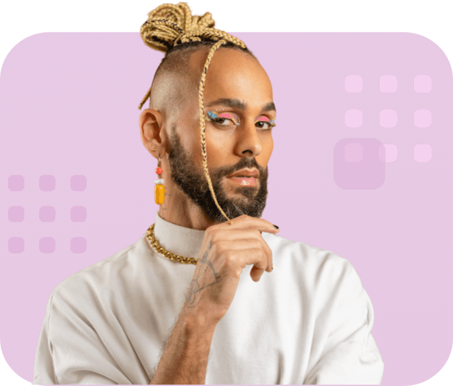Confident individual with braided topknot, beard, colorful eye makeup, and wearing a white top.